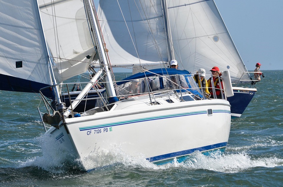 A sailing boat sailing in wind waves